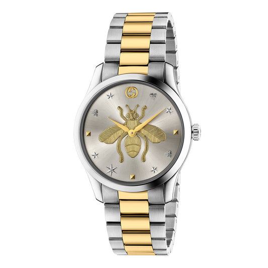 Experience the sophistication of the Gucci G-Timeless Quartz 38mm Watch by GUCCI, featuring a luxurious silver and gold metal band. The dial is adorned with a central Gucci bee design, complemented by star and insect motifs around it. It also includes a sleek silver bezel and a single winding crown on the right side for easy time adjustment.