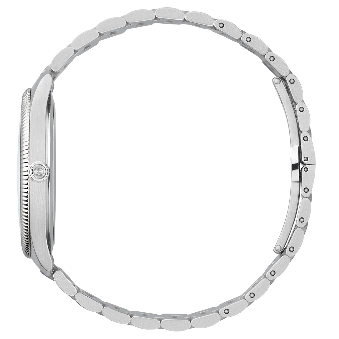 A side view of the elegant Gucci G-Timeless Quartz 38mm Watch showcases its sleek silver design with a smooth stainless steel bracelet. The thin watch case emphasizes its minimalist aesthetic, while the bracelet's interconnected oval links and subtle clasp mechanism complete the look. With quartz movement, this GUCCI watch ensures precision timing.