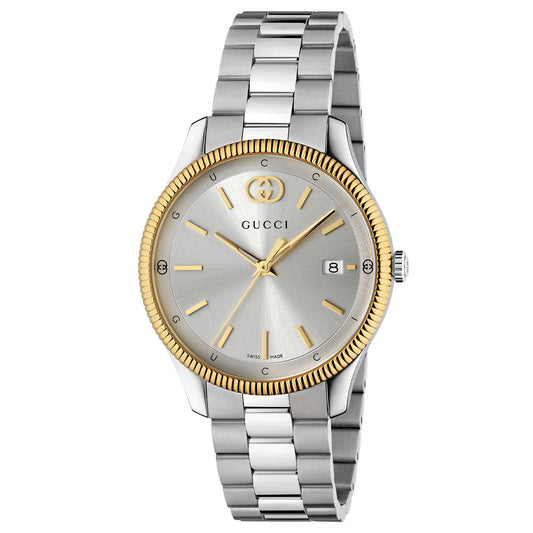 The Gucci G-Timeless Quartz 38mm Watch features a gold bezel, silver dial with gold hour markers, date display at 3 o'clock, and a two-tone silver and gold metal link band. Swiss made by GUCCI Watch.