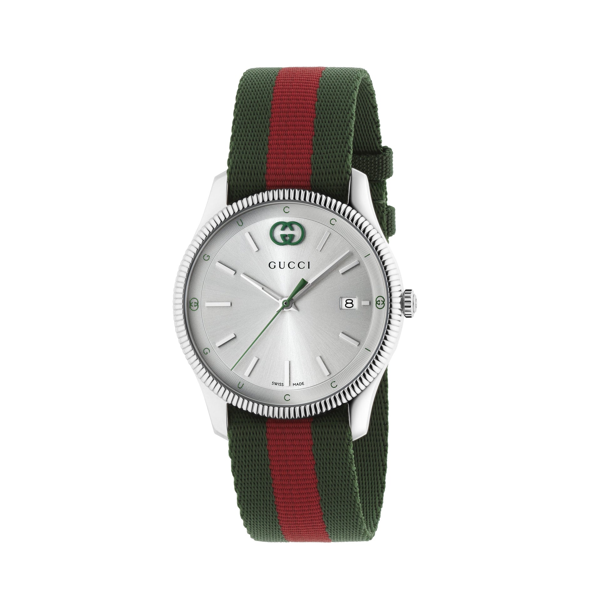 The Gucci G-Timeless Quartz 38mm Watch by GUCCI features a stainless steel case in silver, a minimalist dial with green hour markers, and a distinctive green and red nylon strap with red accents. This watch is complete with a date window located at three o'clock.