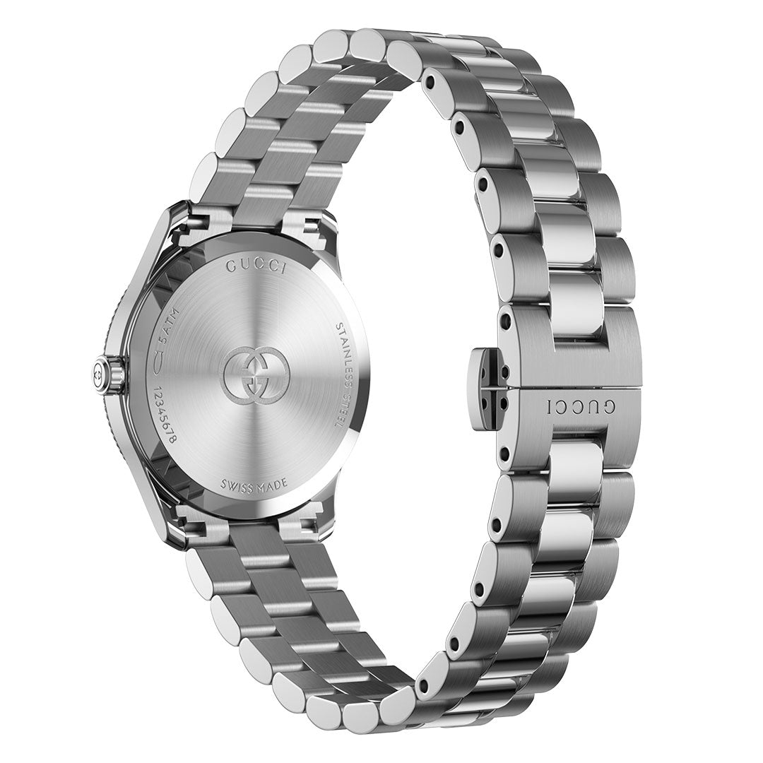 The GUCCI G-Timeless Quartz 29mm Watch is shown from the back, featuring an engraved caseback and a stainless steel bracelet with the Gucci logo on the clasp.