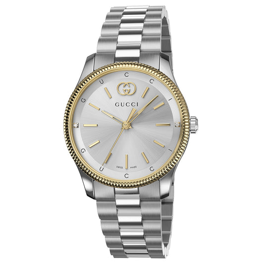 Emphasizing Swiss craftsmanship, the Gucci G-Timeless Quartz 29mm Watch combines a silver metal band with a round face, highlighted by gold hour markers and hands. As part of the esteemed G-Timeless collection, it proudly features the iconic Gucci logo on its silver face. The watch’s elegant design is further accentuated by a gold-toned bezel, creating an exquisite contrast that characterizes GUCCI's luxury timepieces.