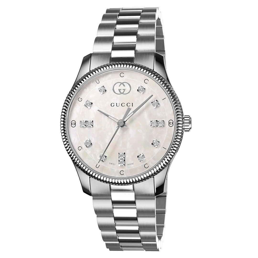 The GUCCI G-Timeless Quartz 29mm Watch features a silver metal link band, mother-of-pearl dial with diamond indexes, Gucci logo at 12 o'clock, and a textured bezel for a sleek, elegant look.