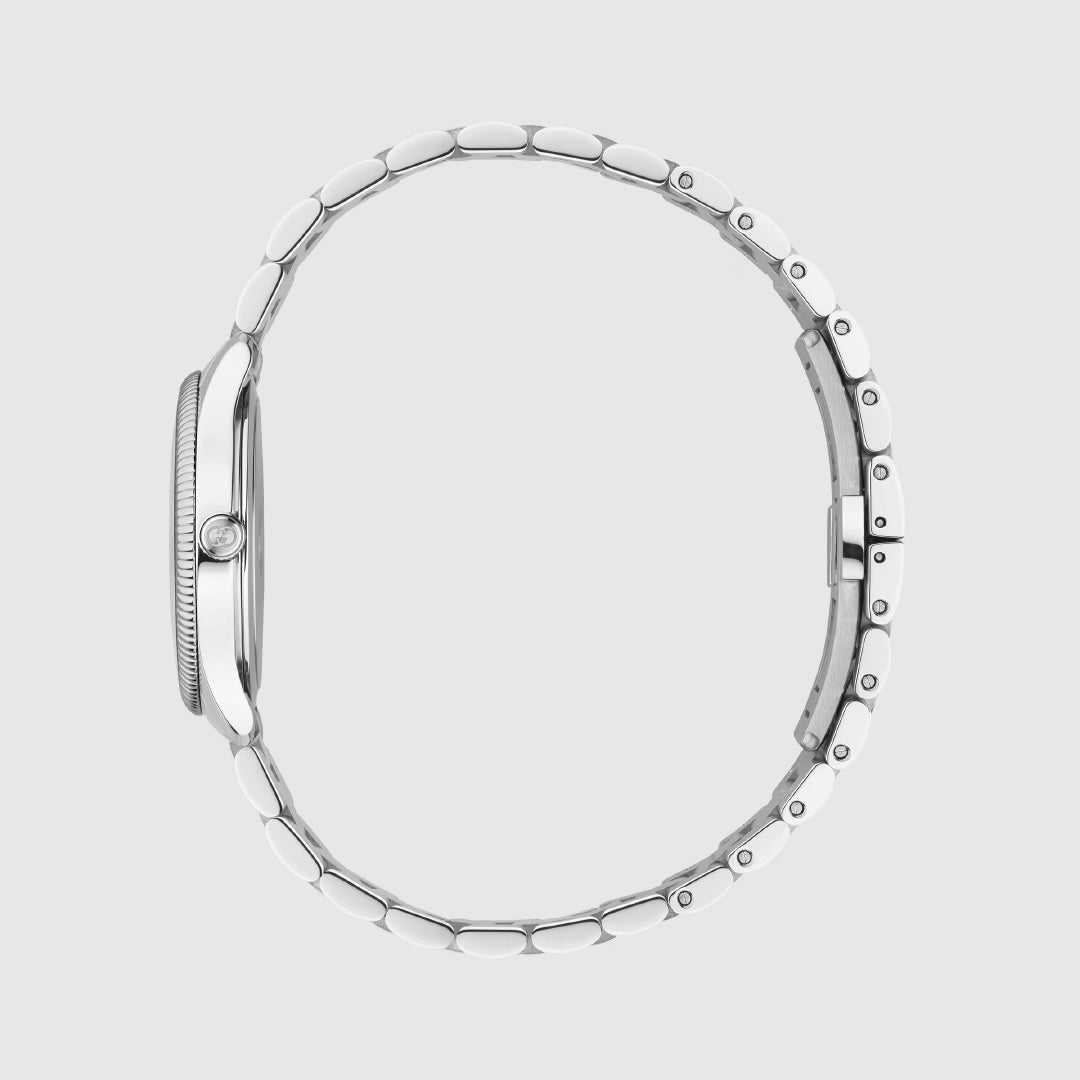 Side view of a Gucci G-Timeless Quartz 29mm Watch by GUCCI, featuring a stainless steel bracelet, round thin case, crown, and clasp, displayed against a plain light gray background.