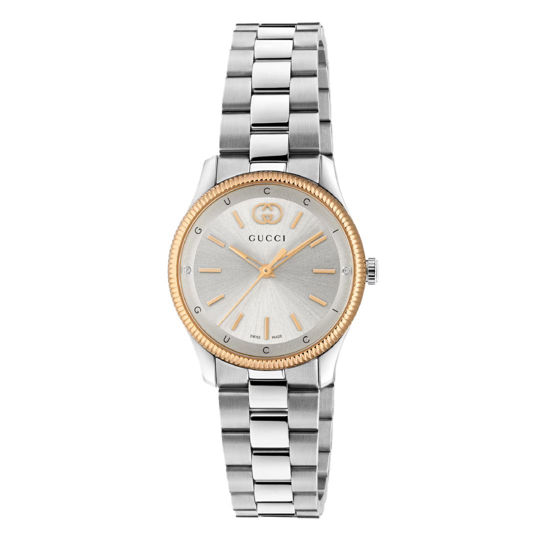The Gucci G-Timeless Quartz 29mm Watch features a silver dial, gold-tone markers and hands, gold bezel, stainless steel bracelet, and the iconic Gucci logo on the face.