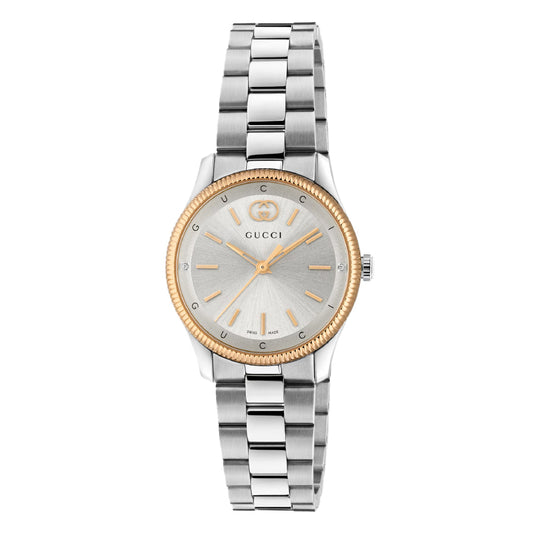 The Gucci G-Timeless Quartz 29mm Watch features a silver dial, gold-tone markers and hands, gold bezel, stainless steel bracelet, and the iconic Gucci logo on the face.