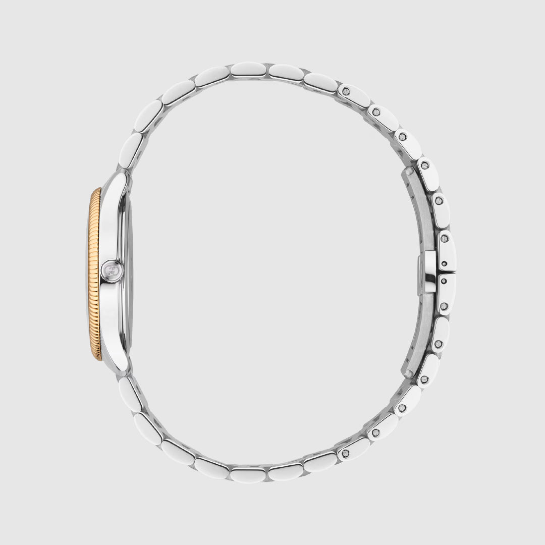 A side view of the Gucci G-Timeless Quartz 29mm Watch by GUCCI, in silver with a gold ridged bezel, round crown, and stainless steel bracelet, displayed on a plain light gray background.