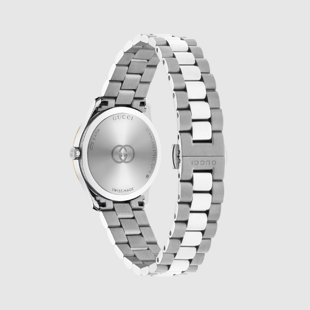 The GUCCI G-Timeless Quartz 29mm Watch in silver and white is displayed from the back, showcasing its stainless steel case with engraved logo, and a sleek bracelet with deployment clasp for an elegant, timeless look.