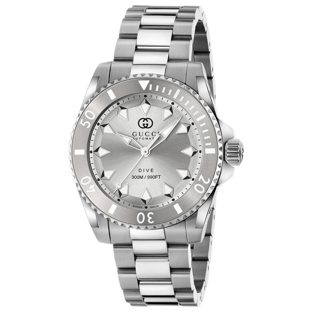 The Gucci Dive Automatic 40mm Watch by GUCCI features a stainless steel case, silver band, rotating bezel, geometric hour markers, luminescent hands and markers, and a dial displaying "Gucci Automatic" and "Dive 300M / 990FT.