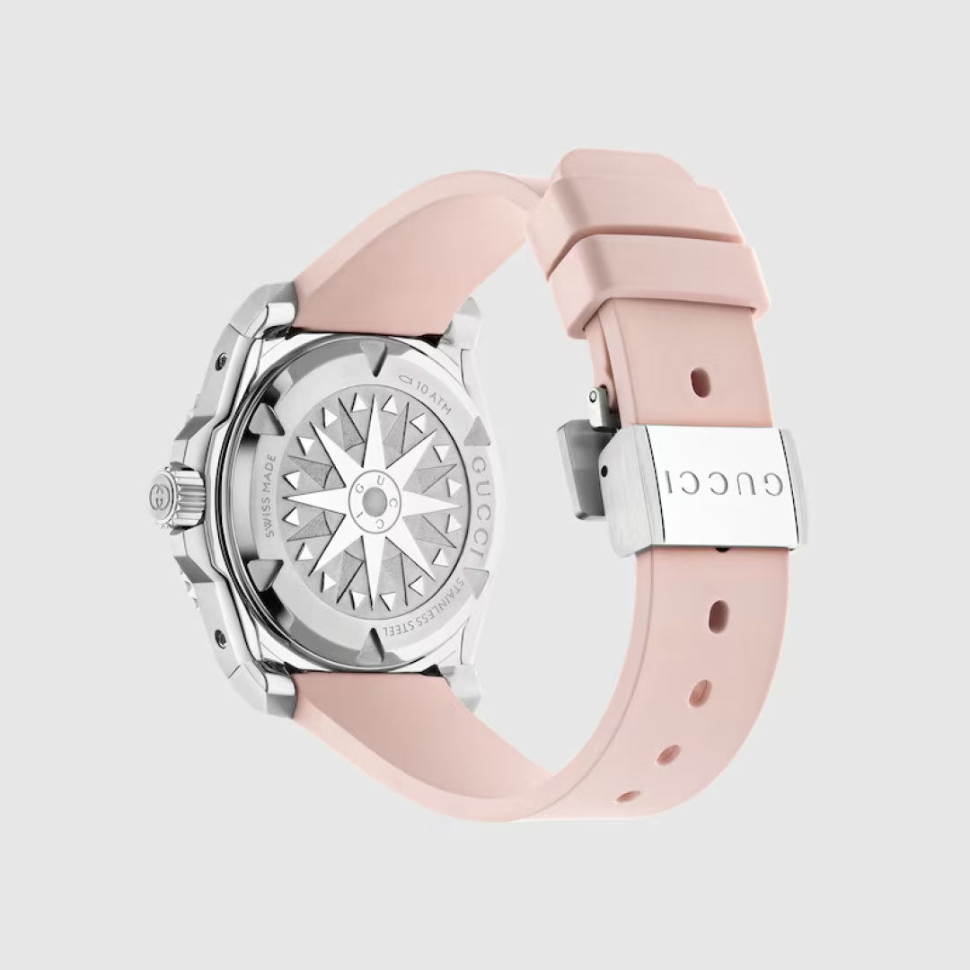 The Gucci Dive Automatic 36mm Watch by GUCCI features a light pink rubber strap, a silver clasp engraved with "GUCCI," and an intricately detailed silver case back—an elegant piece from the Gucci Dive collection.