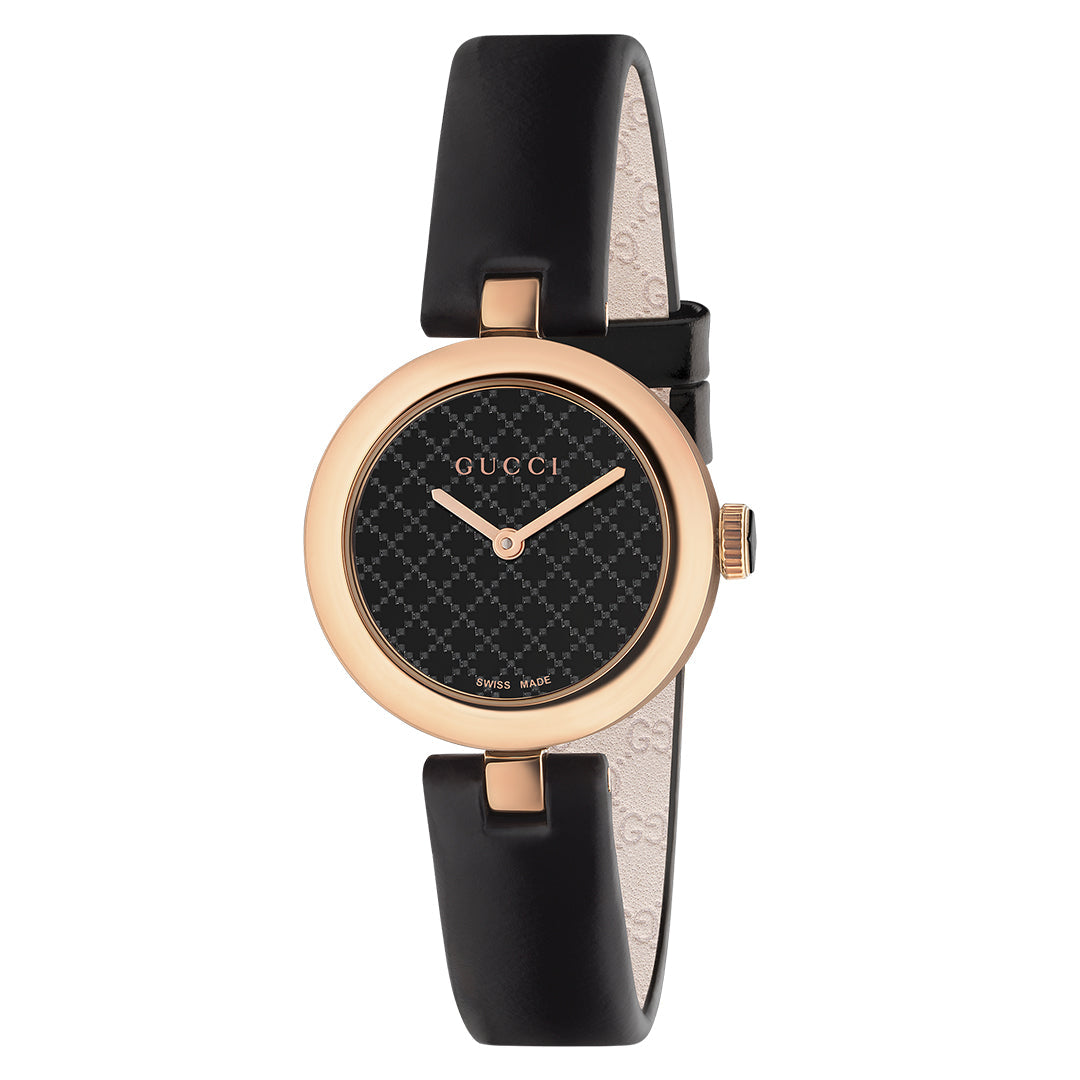 Introducing the Gucci Diamantissima Quartz 27mm Watch, a stylish timepiece featuring a black leather strap and a round gold case. Its black dial boasts a subtle diamante pattern with minimalist gold hands, showcasing the GUCCI watch logo at the top—truly emblematic of Gucci's signature style.