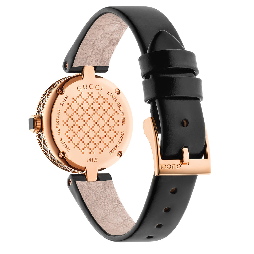 Introducing the Gucci Diamantissima Quartz 27mm Watch, a luxurious timepiece that features a gold-tone case and an elegant black leather strap. The back showcases the iconic "GUCCI" branding along with stainless steel and water-resistant markings. The Diamante pattern on the strap adds an exquisite touch, complemented by multiple holes for adjustable fitting.