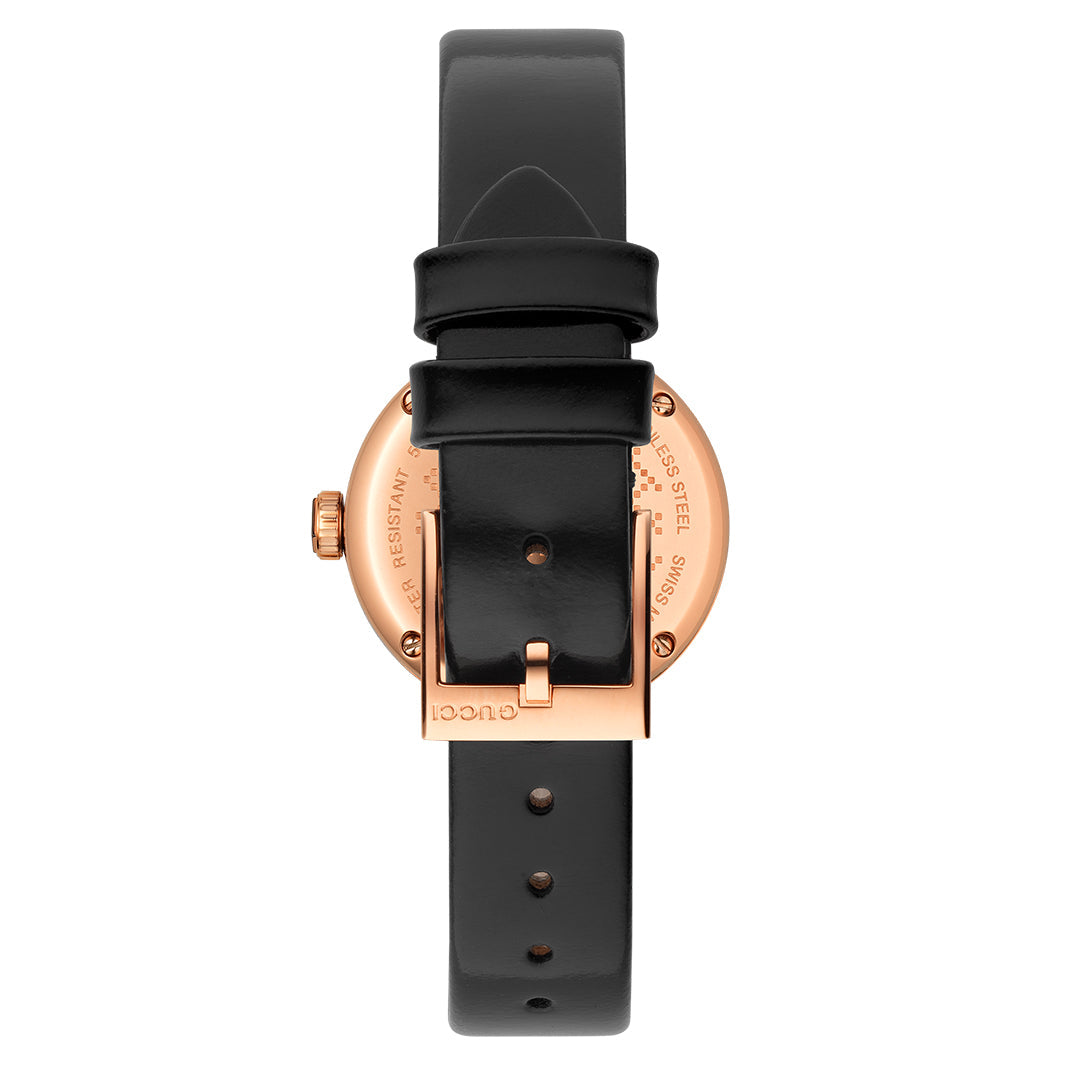 The Gucci Diamantissima Quartz 27mm Watch features a rose gold backplate intricately engraved with details and the GUCCI brand name. Its black leather strap, adorned with a subtle Diamante pattern, is elegantly secured with a classic buckle.