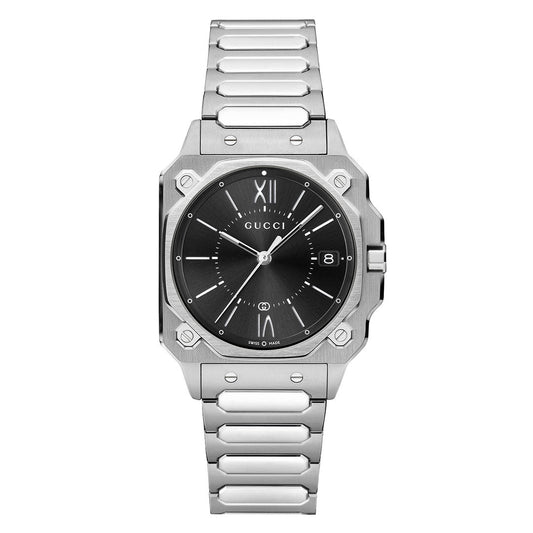 The GUCCI G-Flat Quartz 30mm Watch features a stainless steel case, black galvanized dial, silver hour markers, Roman numerals at 12 and 6, date window at 3 o'clock, and a metal link bracelet.