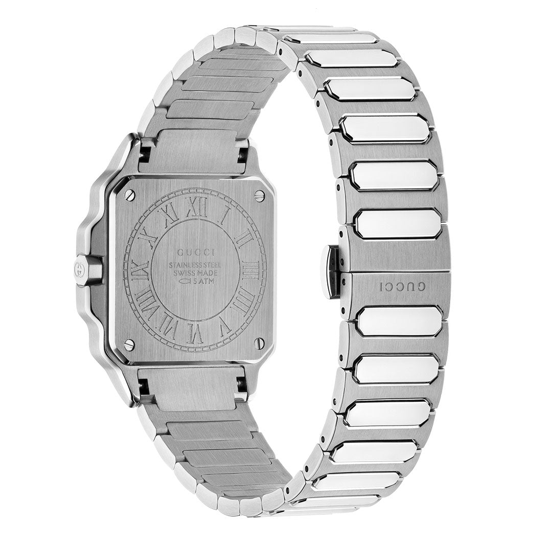 A GUCCI G-Flat Quartz 30mm Watch is shown from the back, featuring a stainless steel engraved case and metal bracelet with “GUCCI” on the clasp. It has a square face with a black galvanized dial and Roman numerals.