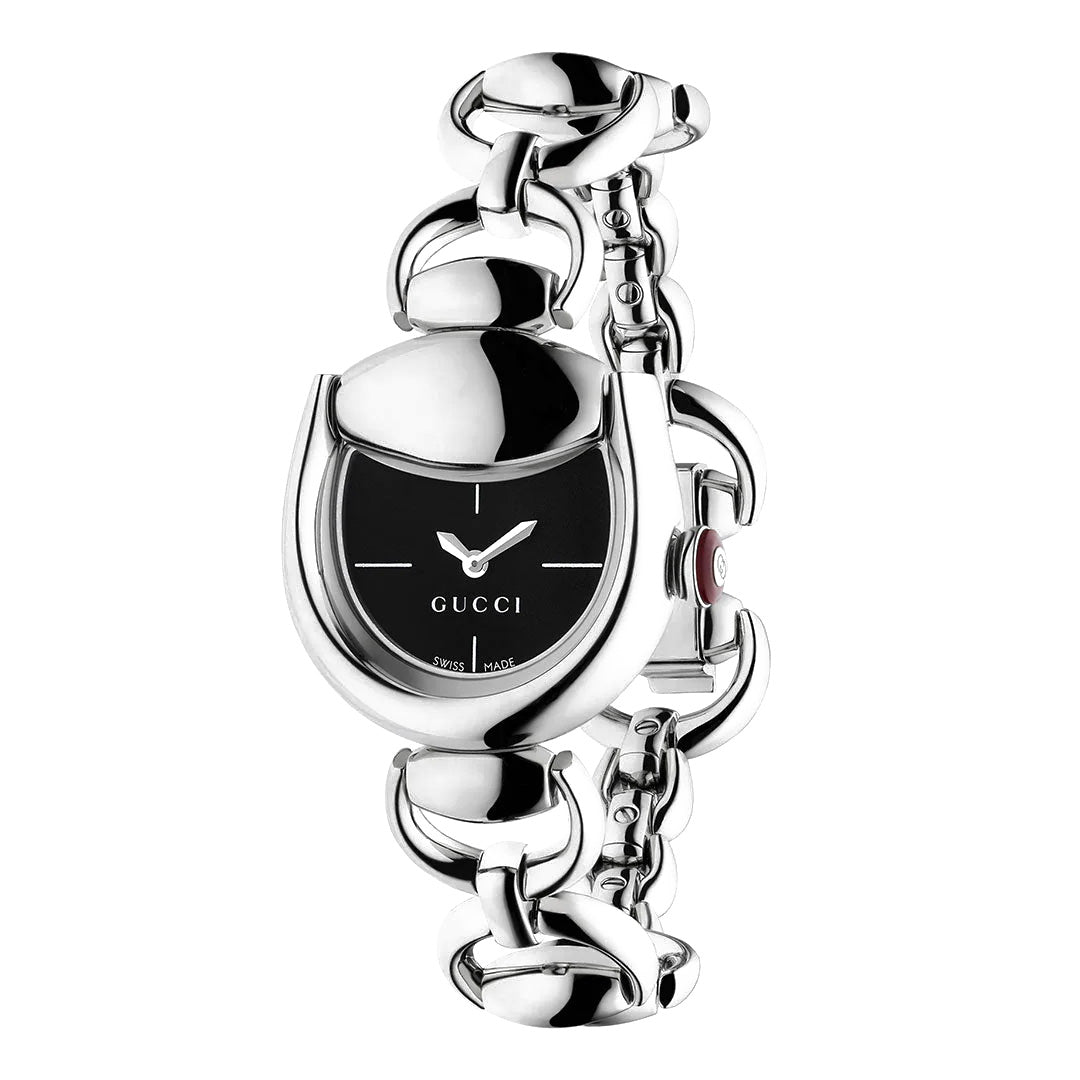 The GUCCI Horsebit Quartz 27mm x 25mm Watch features a sleek silver design with a black oval dial, minimalist markers, silver hour and minute hands, and the iconic Gucci logo. Its chain-link bracelet showcases the signature horsebit motif, and the watch is Swiss Made to ensure exceptional precision.
