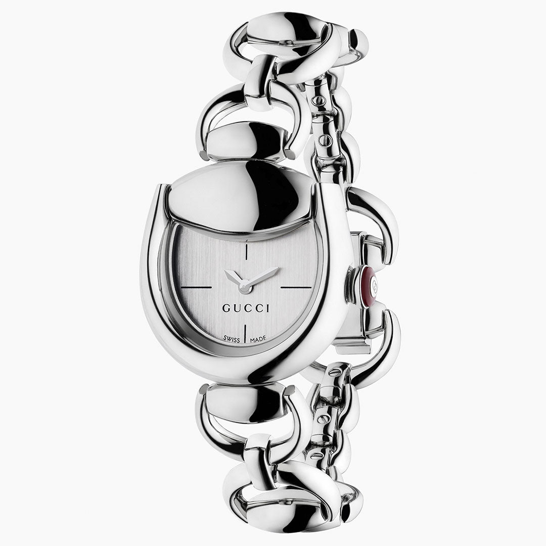 The GUCCI Horsebit Quartz 27mm x 25mm Watch features a silver horsebit-shaped case, white dial with black hands, subtle markers, "GUCCI" at the center, and a chunky stainless steel bracelet—Swiss-made precision.