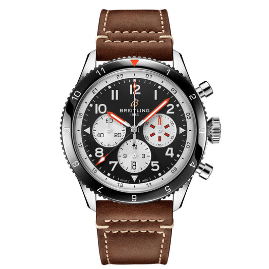 The BREITLING Super AVI B04 Chronograph GMT 46 Mosquito is an elegant pilot's watch that showcases a brown leather strap and silver casing. It features a black dial with three sub-dials, white and red hands, and Arabic numerals, with the 'Breitling' brand name prominently displayed beneath the 12 o'clock position.