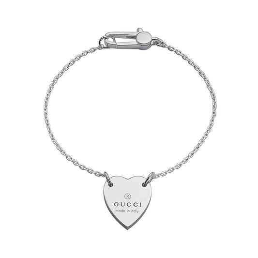 The refined Gucci Trademark Sterling Silver Bracelet With Heart Pendant is skillfully crafted from 925 Sterling Silver, showcasing a heart-shaped charm adorned with the distinguished Gucci logo and an inscription reading "Made in Italy.