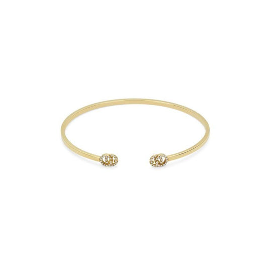 The exquisite Gucci Running G 18K Yellow Gold Diamond Cuff Bracelet, from GUCCI Fine Jewellery, showcases a sleek open bangle design with ball-shaped ends adorned with small diamonds. The elegant piece is beautifully displayed against a plain white background.
