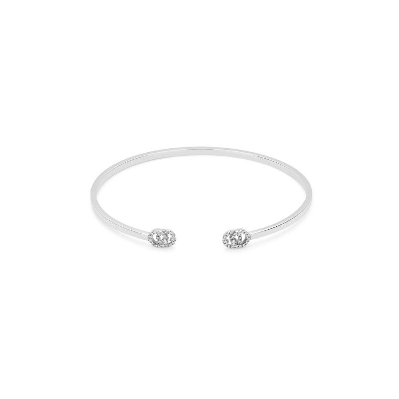 The Gucci Running G 18K White Gold Diamond Cuff Bracelet by GUCCI Fine Jewellery is a minimalist bracelet with an open design, featuring diamond-encrusted round details at each end against a white background.