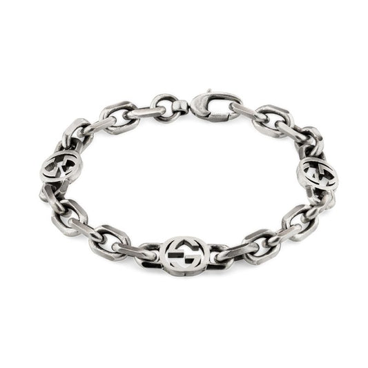 The Gucci Interlocking G Sterling Silver Chain Bracelet by GUCCI Fine Jewellery is a sterling silver piece with large links and multiple circular medallions showcasing the iconic Gucci Interlocking G logo, all presented in an aged finish and secured with a reliable clasp.