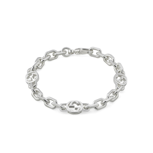 The Gucci Interlocking G Sterling Silver Chain Bracelet by GUCCI Fine Jewellery is crafted with an intertwined design showcasing three interlocking G motifs. This chunky bracelet features a lobster clasp closure and a sleek, polished finish, all displayed against a plain white background.