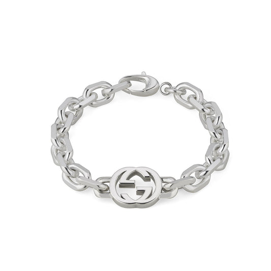 Introducing the Gucci Interlocking G Sterling Silver Chain Bracelet by GUCCI Fine Jewellery, featuring interconnected chain links and a distinctive circular emblem adorned with the iconic double "G" design.
