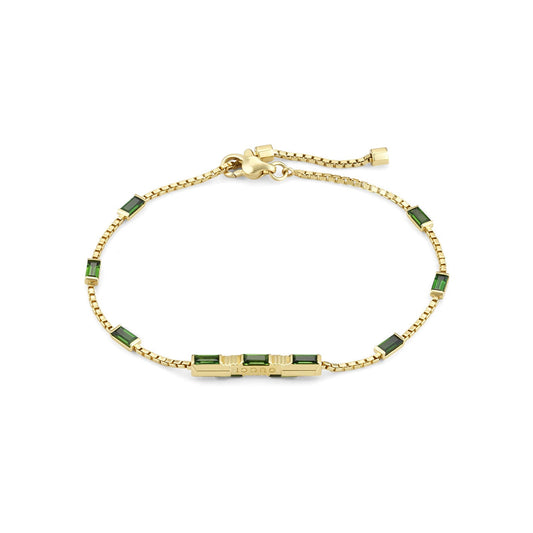 The Gucci Link to Love 18 Karat Yellow Gold Tourmaline Station Bracelet by GUCCI Fine Jewellery is a breathtaking piece featuring green tourmaline rectangular gem accents. It boasts a chain link design and an adjustable clasp for the perfect fit.