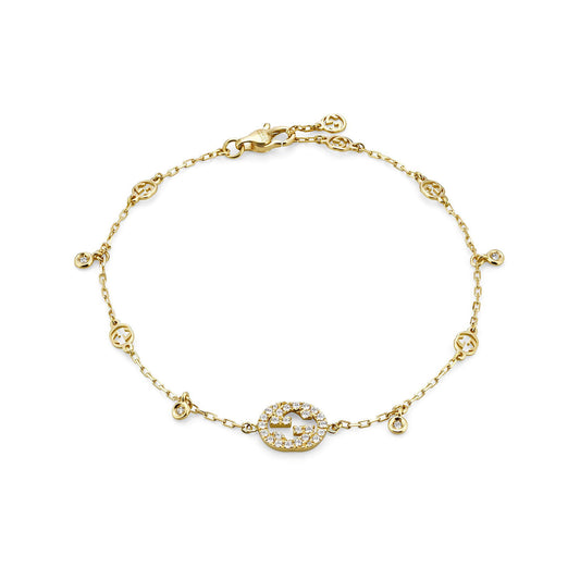 Introducing the Gucci Interlocking G 18K Yellow Gold Diamond Bracelet by GUCCI Fine Jewellery, this stunning piece features an oval-shaped centerpiece embellished with small sparkling stones. The chain, inspired by signature Gucci designs, is accented with decorative elements that enhance its elegance, and it is secured with a lobster clasp for sophistication and style.