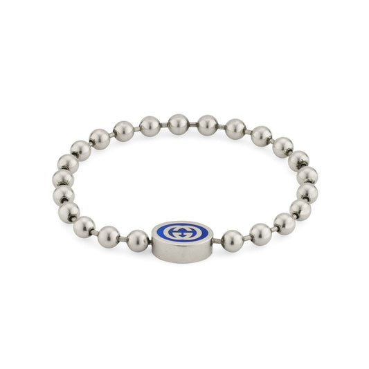 Introducing the Gucci Interlocking G Boule Sterling Silver Bead Bracelet by GUCCI Fine Jewellery. This elegant piece features sterling silver beads adorned with a central round metal component, showcasing a blue enamel emblem. The design effortlessly combines simplicity with sophistication, echoing the timeless aesthetic of Gucci's Interlocking G collection.