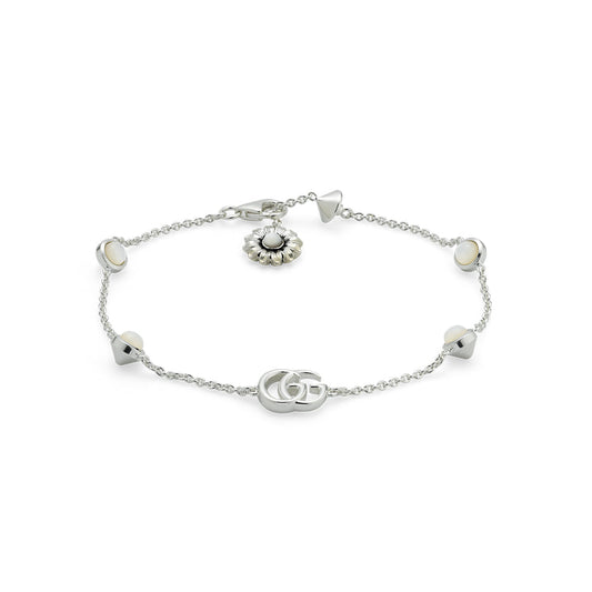 The Gucci GG Marmont Sterling Silver Bracelet by GUCCI Fine Jewellery features a stylish geometric design with interlocking Double Gs and a round flower charm adorned with mother-of-pearl details.