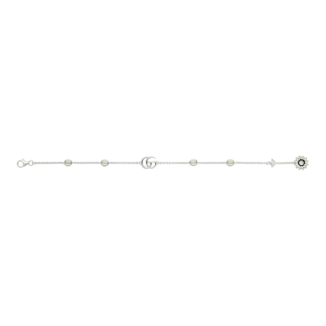 The Gucci GG Marmont Sterling Silver Bracelet by GUCCI Fine Jewellery is a delicate silver chain with small round beads, featuring a central Double G logo and a floral motif accented with mother-of-pearl.