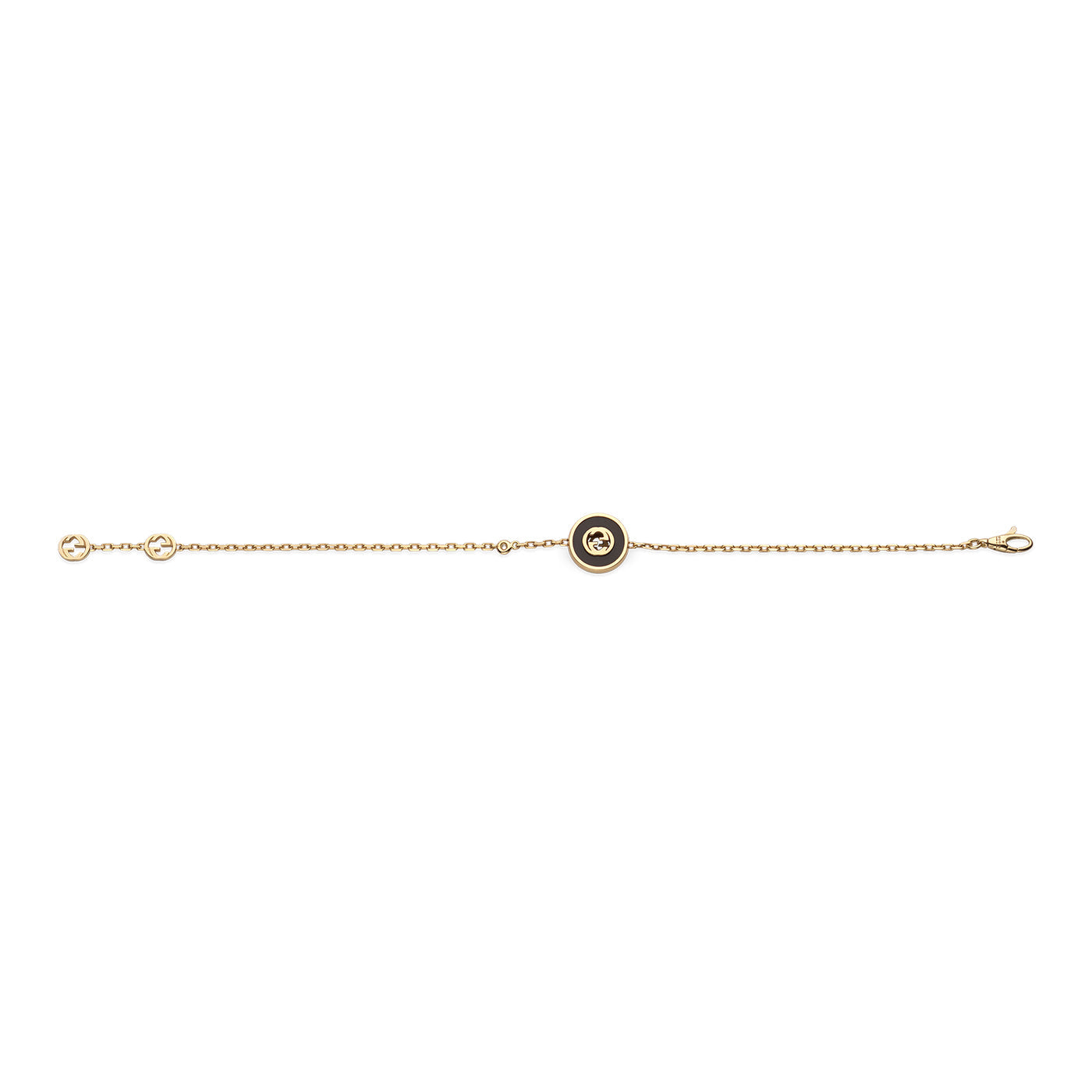 A delicate 18K yellow gold chain bracelet from Gucci Fine Jewellery, featuring two small circular charms and a larger central charm embellished with an onyx heart and the Interlocking G detail.