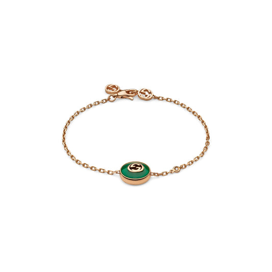 The Gucci Interlocking G 18K Rose Gold Chain Bracelet with Green Agate by GUCCI Fine Jewellery features a delicate chain adorned with a round green agate stone centerpiece and the iconic Interlocking G logo, along with a simple clasp accented by a small, matching logo embellishment.