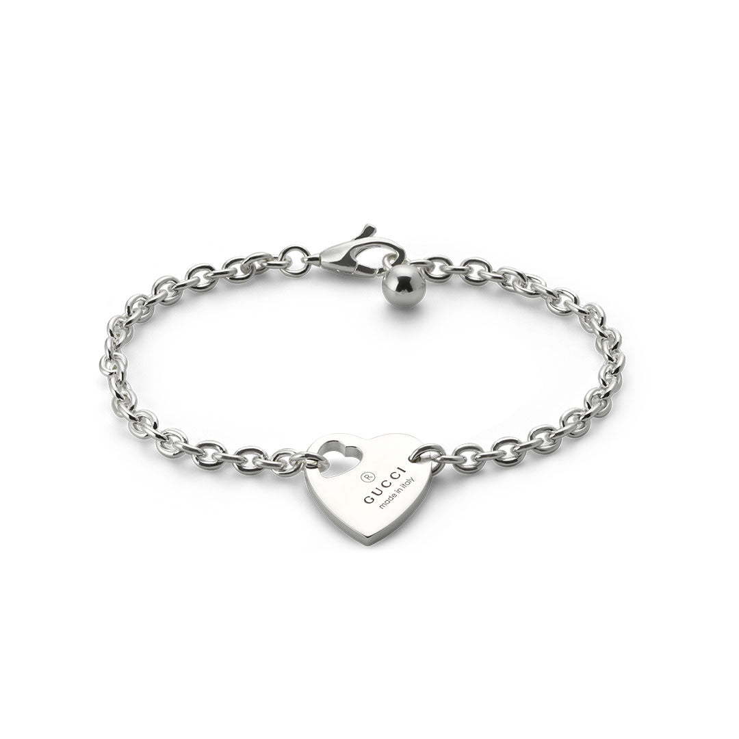 Made from 925 sterling silver, the Gucci Trademark Sterling Silver Bracelet With Charm features a heart-shaped pendant with the "GUCCI" engraving and "Made in Italy." It includes a secure clasp fastening and a small metal bead near the clasp, accentuating its GUCCI Fine Jewellery elegance.