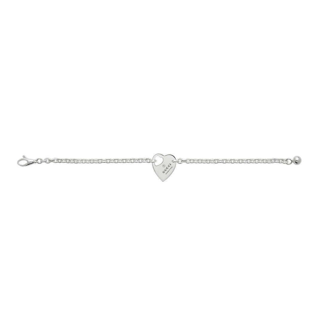 Introducing the Gucci Trademark Sterling Silver Bracelet With Charm by GUCCI Fine Jewellery, a 925 sterling silver bracelet adorned with a heart-shaped charm featuring engraved text. This sophisticated piece is elegantly showcased on a plain white background, embodying the classic Gucci Trademark aesthetic.