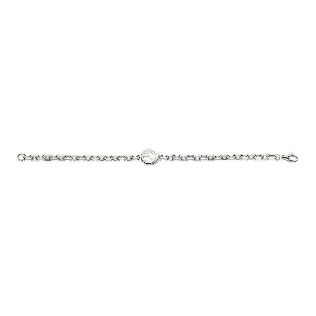 The GUCCI Fine Jewellery's Gucci Interlocking G Sterling Silver Bracelet features a 925 sterling silver chain with a round polished centerpiece and engraved detail. It secures with a clasp, boasting a simple yet elegant design accented by an interlocking G charm.