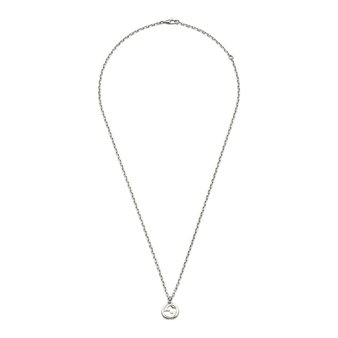 The Gucci Interlocking G Sterling Silver Necklace Pendant by GUCCI Fine Jewellery features a 925 sterling silver chain and a central circular pendant with the Interlocking G motif, offering minimalist elegance. The thin chain ends with a small clasp, embodying understated sophistication.