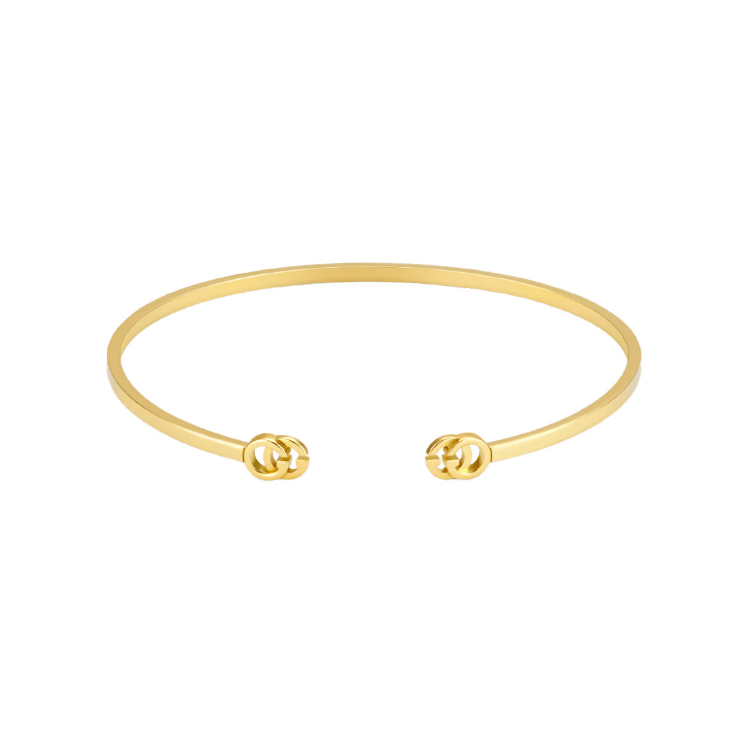 The Gucci GG Running 18K Yellow Gold Cuff by GUCCI Fine Jewellery features a minimalist open design with interlocking double G logos at each end, crafted with responsible jewelry practices.