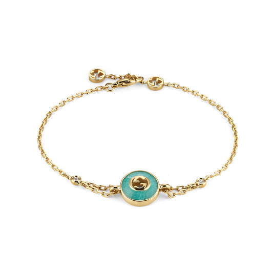 The Gucci Interlocking 18K Yellow Gold Diamond Bracelet with Amazonite by GUCCI Fine Jewellery features a round amazonite center, diamond accents, GG logos, and an adjustable clasp.