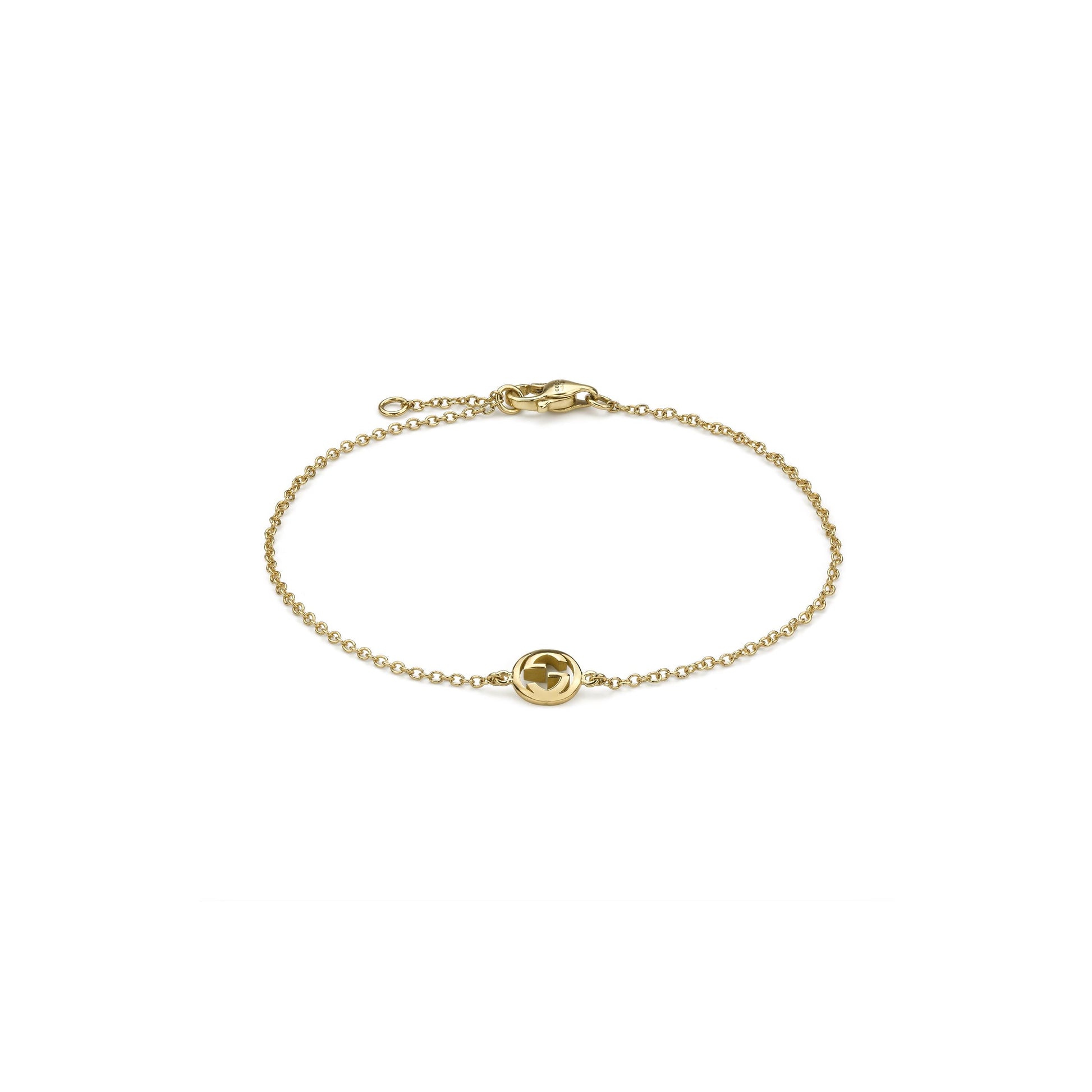 The Gucci Interlocking 18K Yellow Gold Chain Bracelet by GUCCI Fine Jewellery features a fine chain, a small circular Interlocking G charm, and a secure lobster clasp.