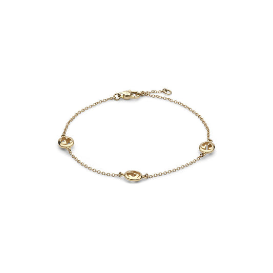 The Gucci Interlocking 18K Yellow Chain Bracelet by GUCCI Fine Jewellery features four evenly spaced round anchor cut-out charms and a lobster clasp, crafted in Italy from delicate yellow gold.