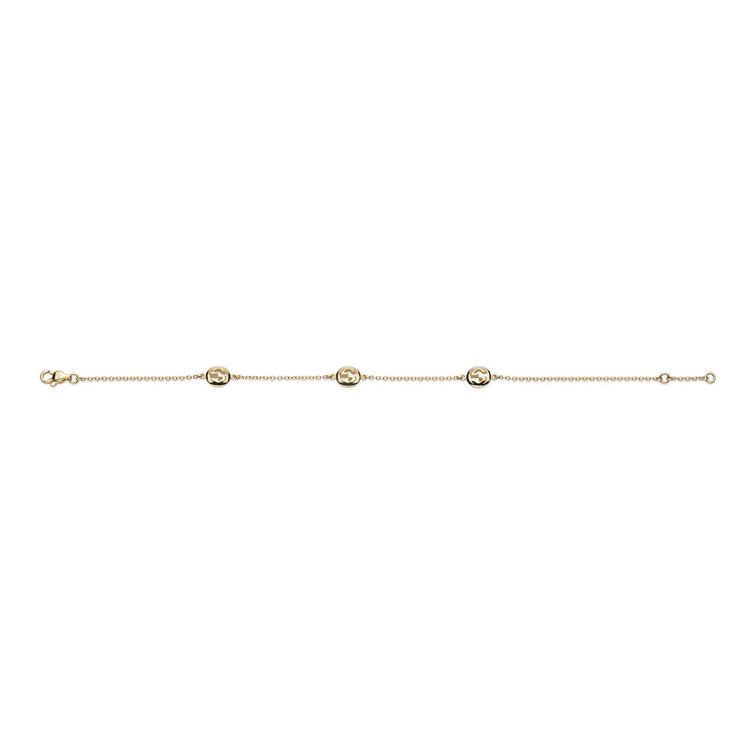 The Gucci Interlocking 18K Yellow Chain Bracelet by GUCCI Fine Jewellery features three evenly spaced circular cut-out charms, crafted in Italy for timeless elegance and displayed on a white background.