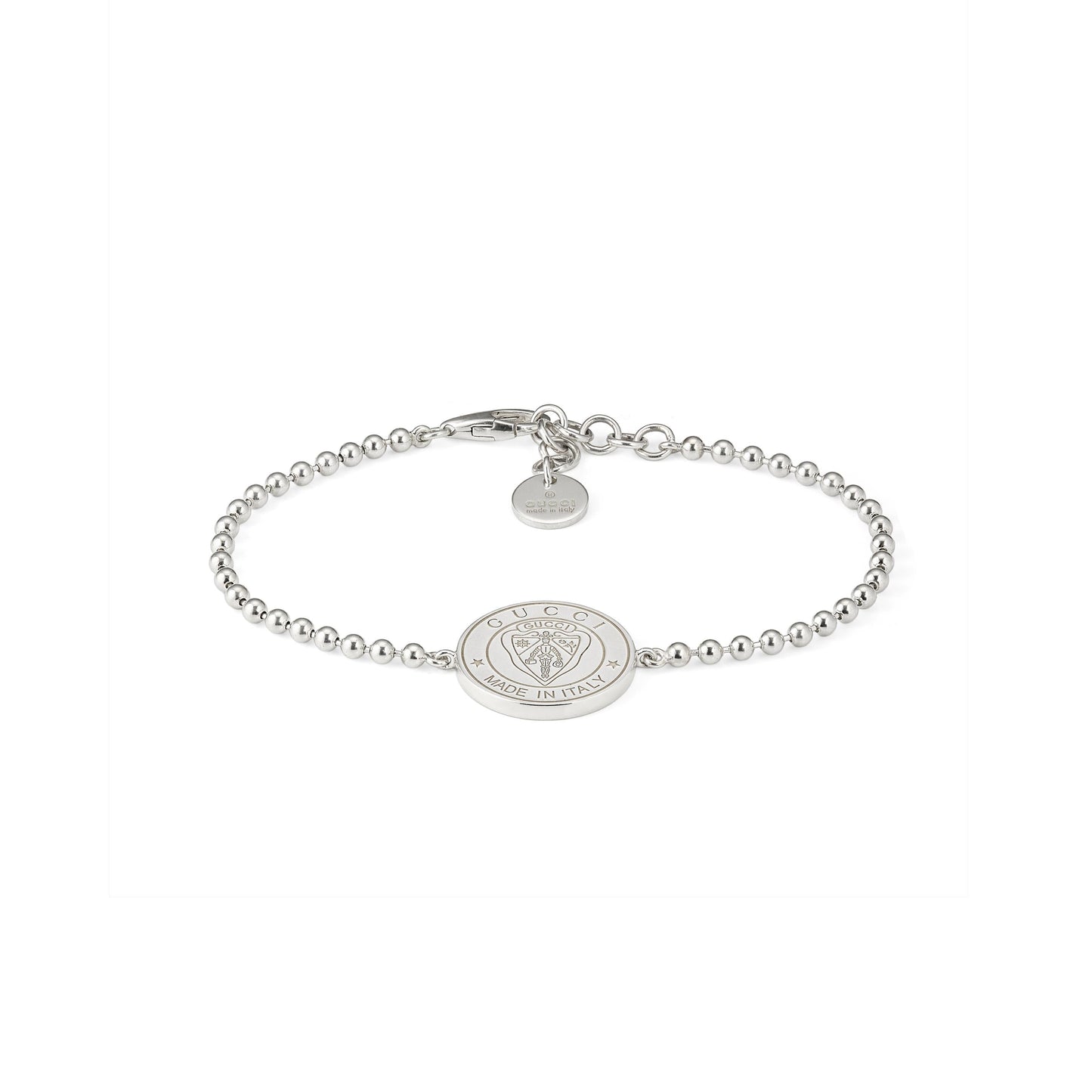 The Gucci Crest Sterling Silver Boule Bracelet by GUCCI Fine Jewellery features 925 sterling silver beads, a central engraved crest charm, and a small round tag near the clasp, all in a minimalist design. Displayed on a white background.