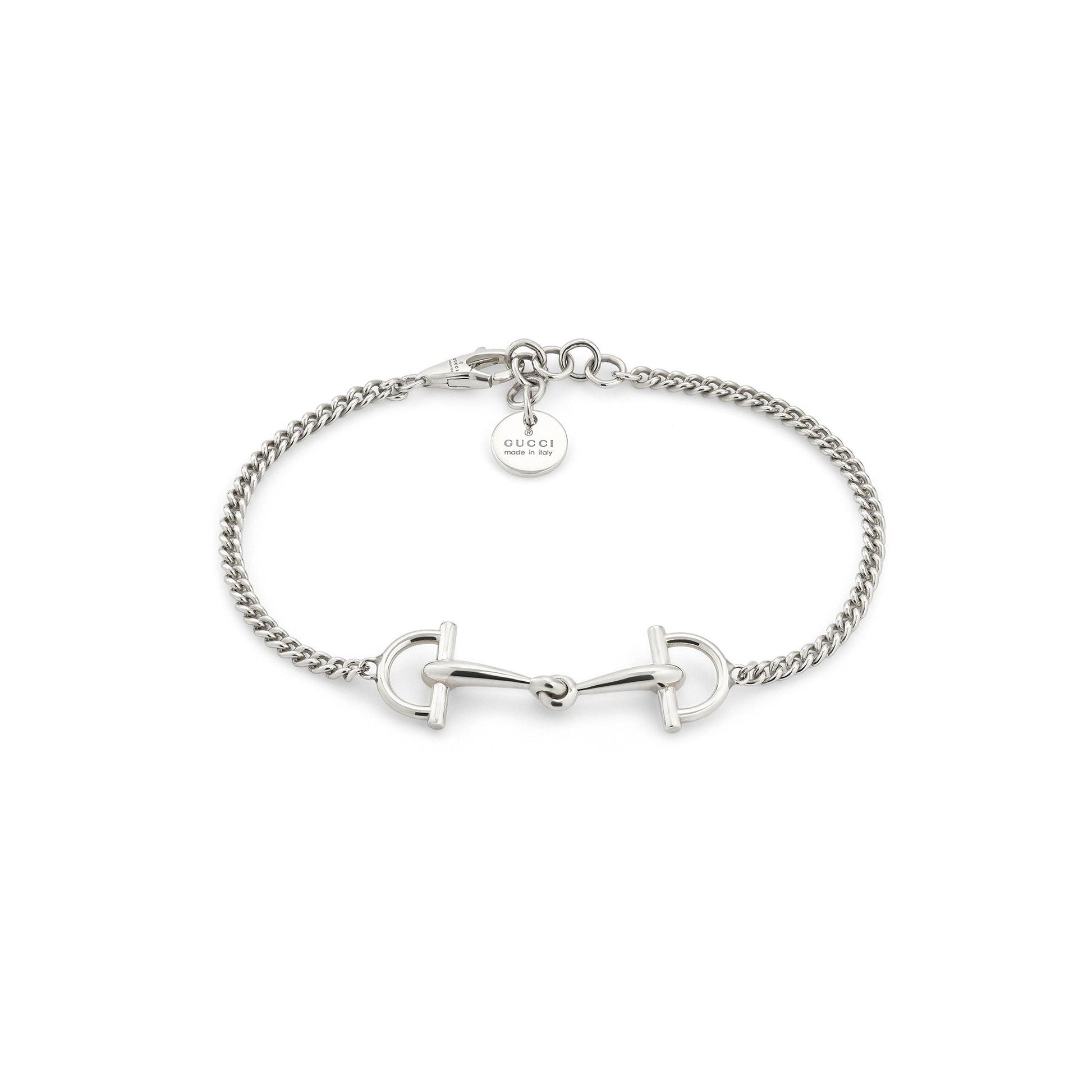 The Gucci Staffa Sterling Silver Station Bracelet by GUCCI Fine Jewellery features a horsebit design and a round Gucci tag near the clasp, all beautifully displayed on a white background.