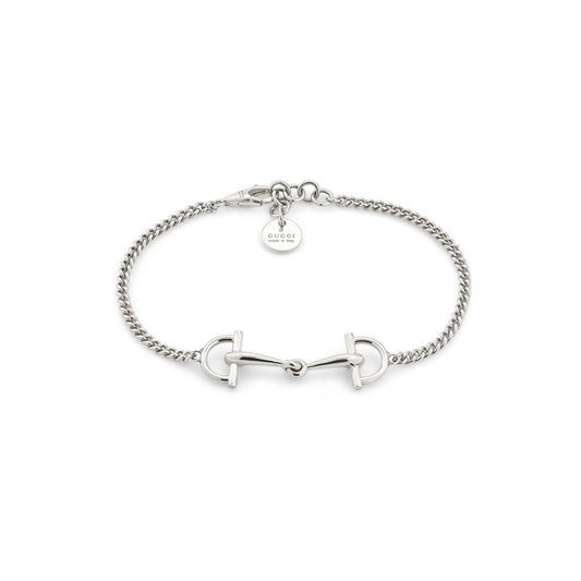 The Gucci Staffa Sterling Silver Station Bracelet by GUCCI Fine Jewellery features a horsebit design and a round Gucci tag near the clasp, all beautifully displayed on a white background.