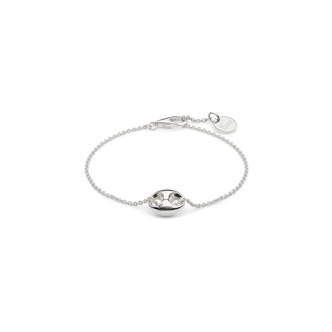 Gucci Marina Sterling Silver Chain Bracelet in sterling silver, featuring a central anchor-shaped link with Gucci script engraving and a small circular charm at the clasp.