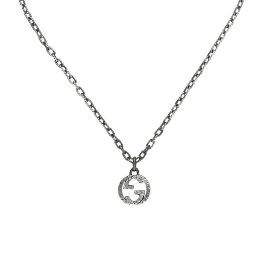 The Gucci Interlocking G Sterling Silver Necklace by GUCCI Fine Jewellery boasts a round pendant with an iconic cut-out "G" at its center, accented by a textured border for subtle detailing. This minimalist and elegant piece suits any attire, adding sophistication to your collection. Expertly crafted in Italy, it's a refined addition to any ensemble.