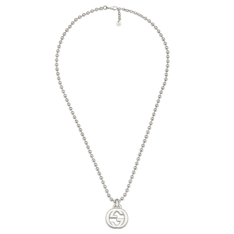 The Gucci Interlocking G Sterling Silver Necklace Pendant from GUCCI Fine Jewellery features a boule chain with a circular pendant displaying a stylized interlocking design akin to the iconic Gucci Interlocking G. It includes a simple and adjustable clasp.